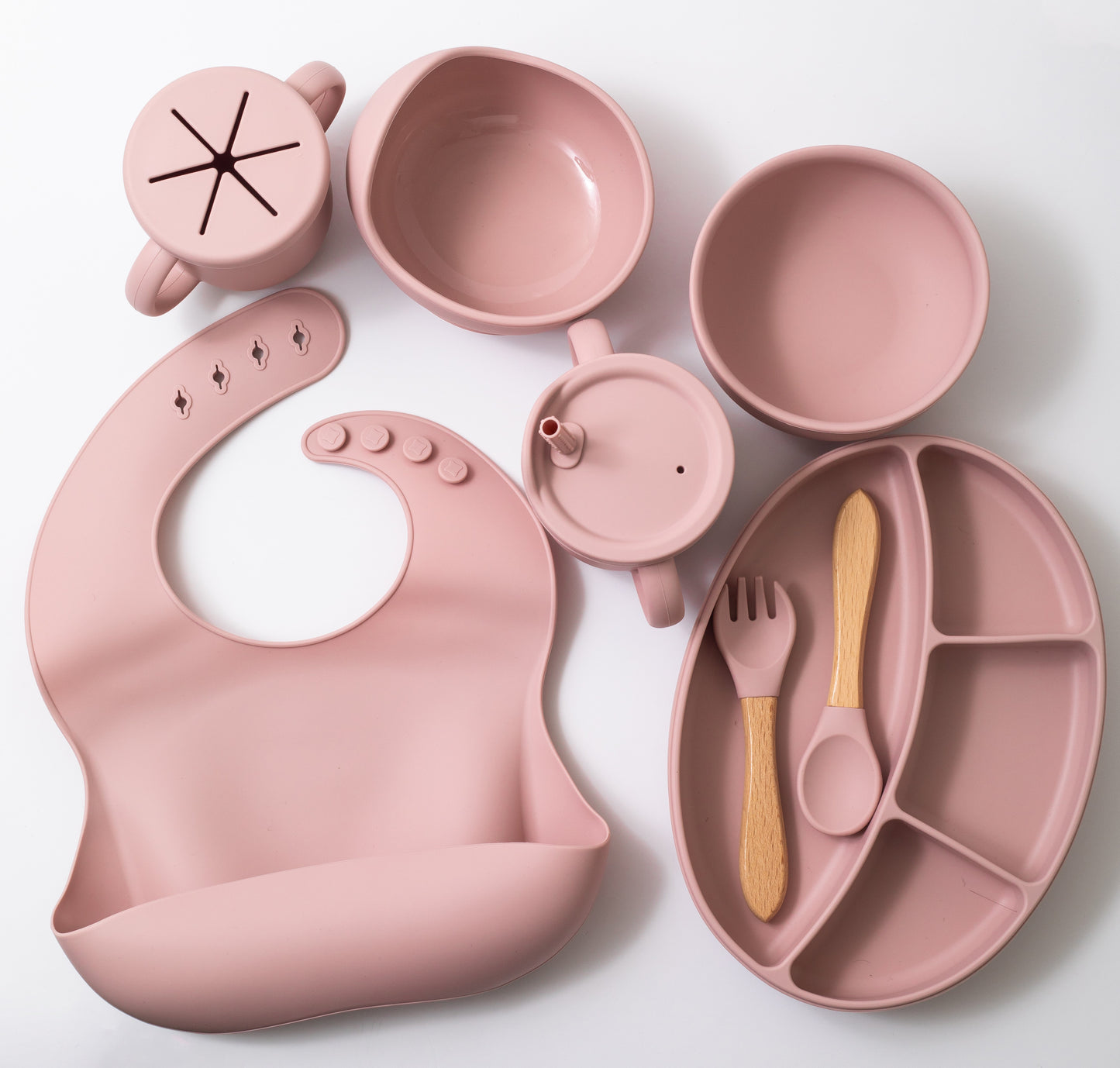 Silicon baby feeding dinner set having weaning bowl round bowl bib sectioned plate spoon sippy cup snack cup and fork in pink color