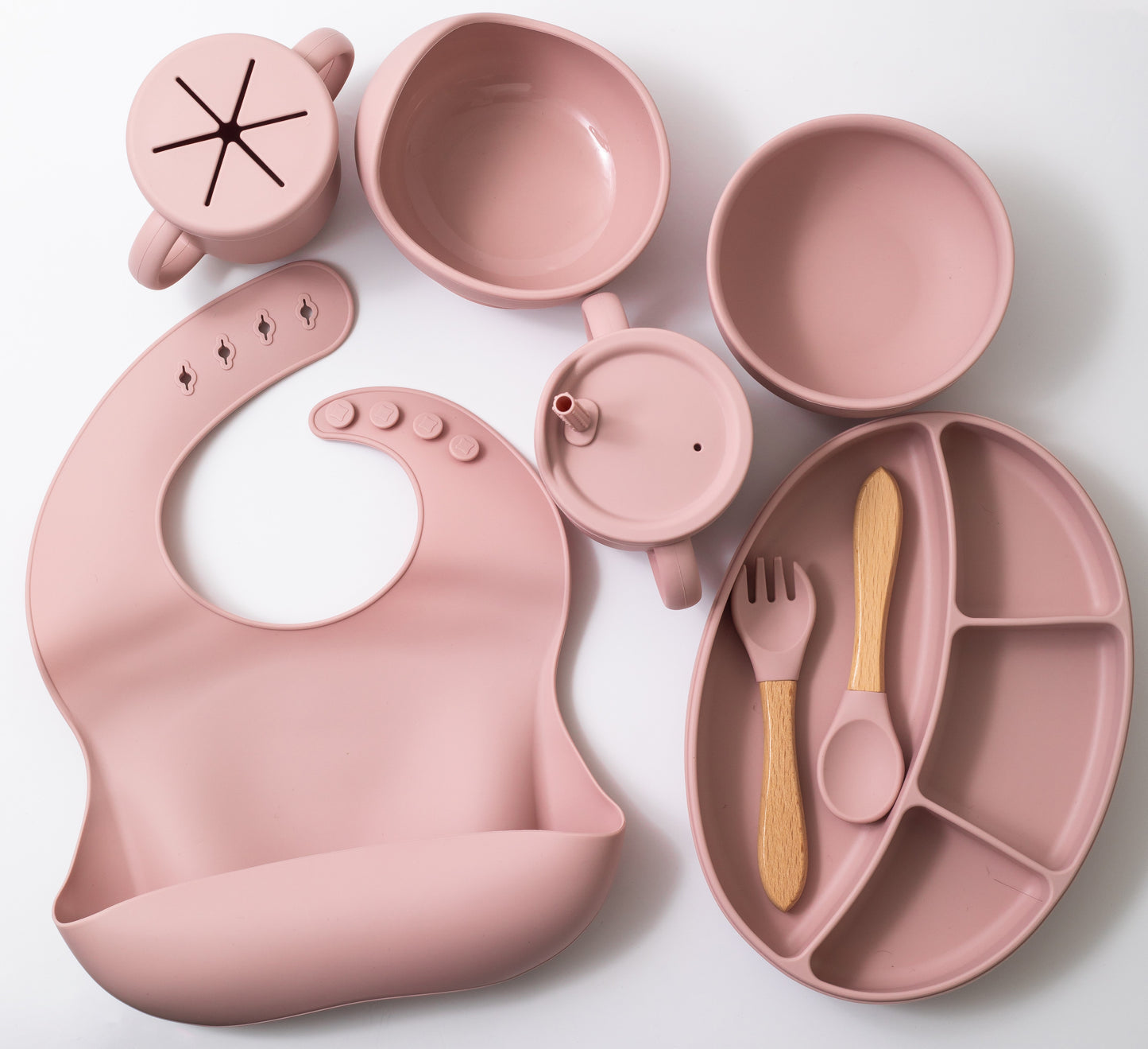 Silicon baby feeding dinner set having weaning bowl round bowl bib sectioned plate spoon sippy cup snack cup and fork in pink color