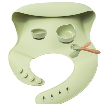 Silicon baby feeding dinner set having weaning bowl round bowl bib  spoon  and fork in green color