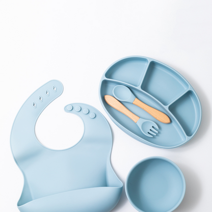 silion baby feeding dinner set having  spoon fork round bowl sectioned plate and  bib in blue color