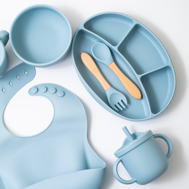 Silicon baby feeding dinner set having round bowl bib sectioned plate spoon sippy cup and fork in blue color