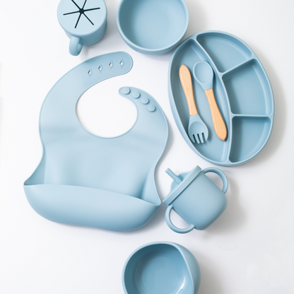 Silicon baby feeding dinner set having weaning bowl round bowl bib sectioned plate spoon sippy cup snack cup and fork in blue color