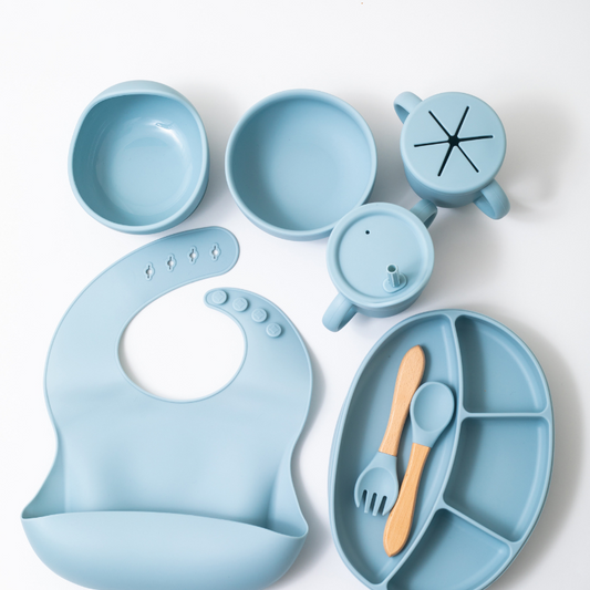 Silicon baby feeding dinner set having weaning bowl round bowl bib sectioned plate spoon sippy cup snack cup and fork in blue color