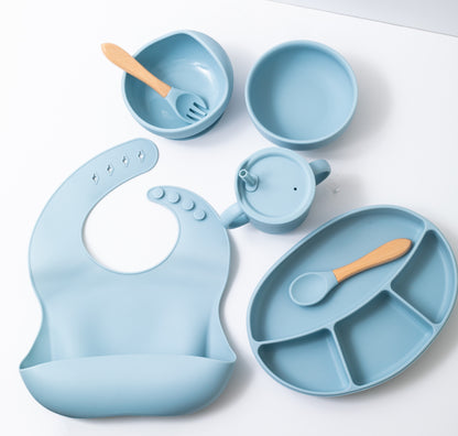 Silicon baby feeding dinner set having weaning bowl round bowl bib sectioned plate spoon sippy cup and fork in blue color