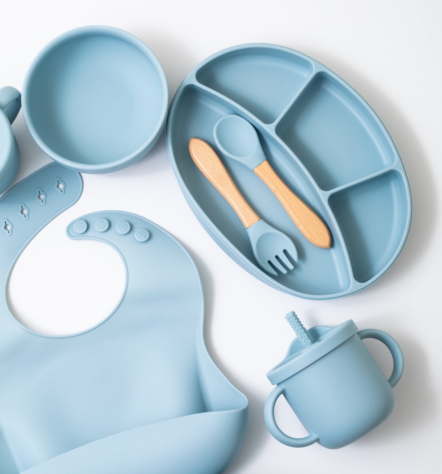 Silicon baby feeding dinner set having round bowl bib sectioned plate spoon sippy cup and fork in blue color