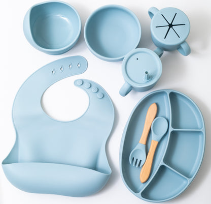 Silicon baby feeding dinner set having weaning bowl round bowl bib sectioned plate spoon sippy cup snack cup and fork in blue color