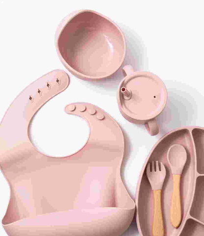 Silicon baby feeding dinner set having weaning bowl bib sectioned plate spoon sippy cup and fork in pink color
