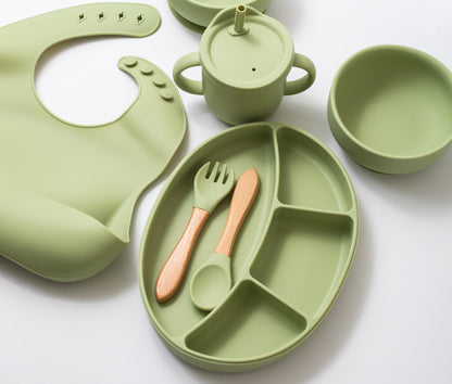 Silicon baby feeding dinner set having round bowl bib sectioned plate spoon sippy cup and fork in green color