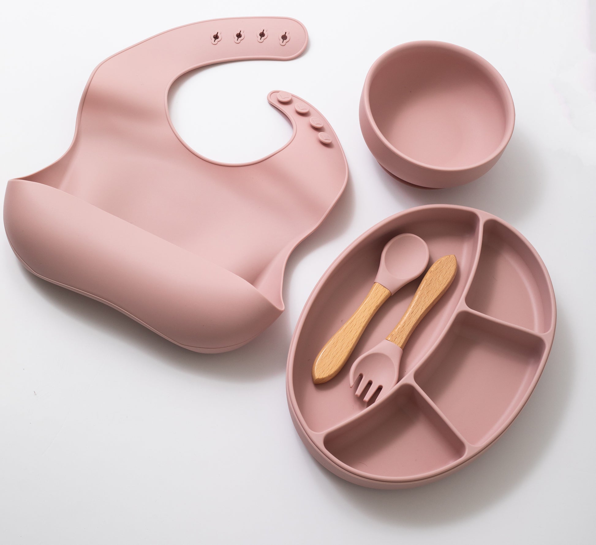 silion baby feeding dinner set having spoon fork round bowl sectioned plate and bib in pink color